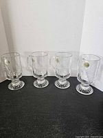 Four crystal mugs side by side