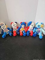 Group shot of all five USA Ring Bears plush toys