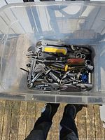Top view of tote showing assorted sockets, wrenches, pliers and screwdrivers