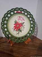 front view showing floral design and green pierced rim