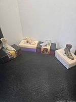 Group shot of four miniature shoes on their boxes