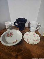 Group shot of three mugs, saucer and bowl