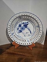 Front view of bowl showing blue floral design and reticulated rim