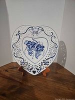 Front view showing heart shape, pierced border, blue grape motif