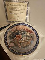 Plate in factory foam with Certificate of Authenticity visible