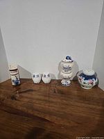 All five ceramic shakers lined up on table for full lot overview
