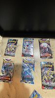 Six assorted Pokémon booster packs displayed face up