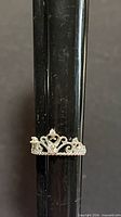 Ring on mandrel showing crown design and silver finish
