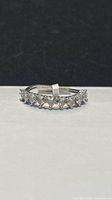 Side profile of sterling silver eternity ring showing continuous stones and .925 hallmark