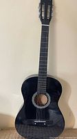 Full view of black Academy classical guitar