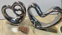 Two metal heart incense dispensers and incense bead bag