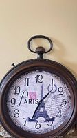 Front view showing entire clock, bronze frame, Paris Eiffel Tower dial