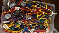 Top view of bin showing large quantity of mixed K'NEX rods, connectors, wheels and gears
