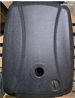 Top view of black resin umbrella base showing pole socket and fill cap