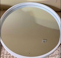 front view of white round mirror