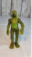 Front view of translucent green Creature from the Black Lagoon figurine