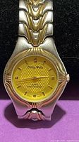 Front view showing yellow dial and two-tone bracelet