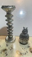 Candle stand and pineapple burner side by side