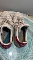 Top view of both shoes showing tongues, laces, heel tabs