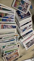 Top view of several stacks of baseball cards spread out on surface