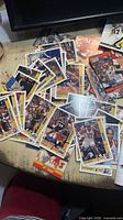 Spread of mixed football and basketball trading cards on table