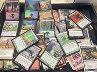 Tray with mixed MTG cards, variety of colors and a foil land visible