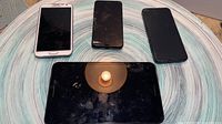 Front view showing three smartphones and one tablet
