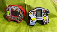 Front view of both Sega LCD handheld games displaying graphics and controls