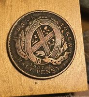 Reverse of 1837 Bank of Montreal half penny token showing wreath and shield