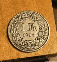 Obverse of coin showing 1 Fr and 1914 within wreath