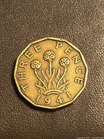 Reverse of 1941 threepence coin showing thrift plant and denomination
