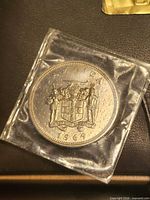 Obverse of 1969 Jamaica 20 cents coin in plastic