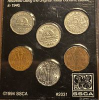 Back of display card with explanatory text and coins visible