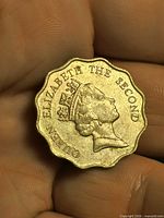 Obverse showing Queen Elizabeth II on scalloped edge coin