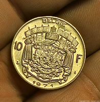 Reverse side of 1971 Belgium 10 F coin showing coat of arms and value
