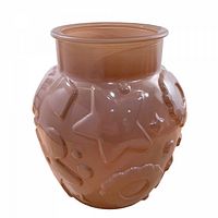 front view of butterscotch glass cookie jar showing embossed motifs and flared mouth