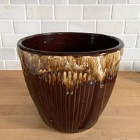 Front view of ribbed brown drip glaze jardiniere