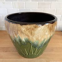 Front view showing drip glaze and embossed pattern