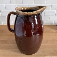 Front view of brown drip glaze pitcher
