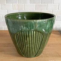 Front view showing fluted Gothic panels and green drip glaze