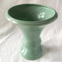 Angled top view showing aqua glaze, flared rim and pedestal foot