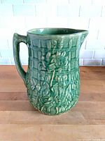 Front/side view showing overall shape, trellis and rose relief, green glaze