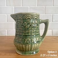 Left side view showing relief design, handle, spout and glaze colour