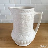 Front view of matte white Rosella #320 pitcher showing basket weave and bird relief