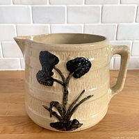 Front view showing black lily motif and spout