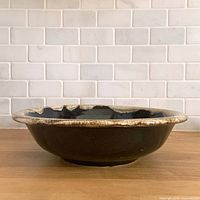 Side profile showing brown body and cream drip rim