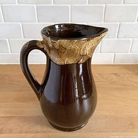 Three-quarter view showing handle, spout and glaze contrast