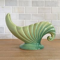 Left side profile of chartreuse cornucopia vase