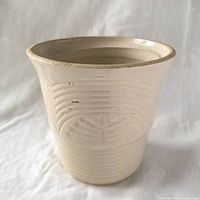 cream glazed stoneware planter front view showing relief pattern