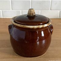 Front view of brown drip sugar bowl with lid